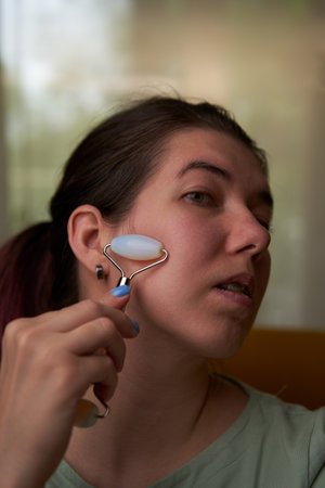 Woman is massaging her face roller.の写真素材