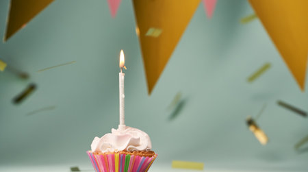 Colorful cupcake with single birthday candle.の写真素材