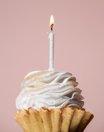 Colorful cupcake with single birthday candle.の写真素材