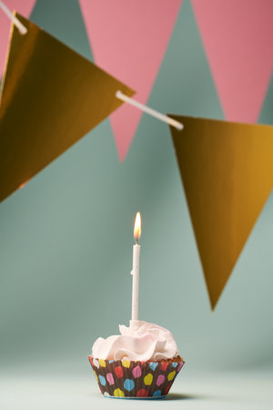 Colorful cupcake with single birthday candle.の写真素材