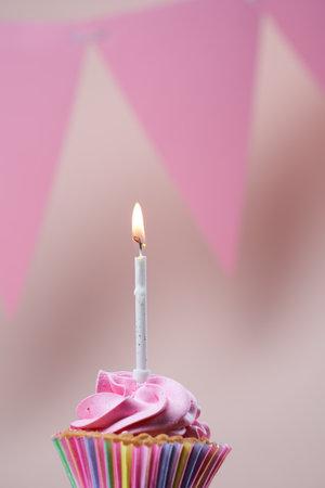 Colorful cupcake with single birthday candle.の写真素材