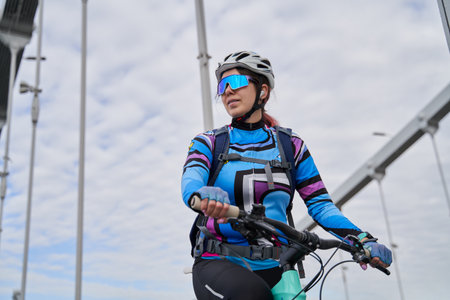 Portrait of a cyclist woman against the background of the city.の写真素材