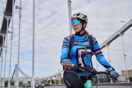 Portrait of a cyclist woman against the background of the city.の写真素材