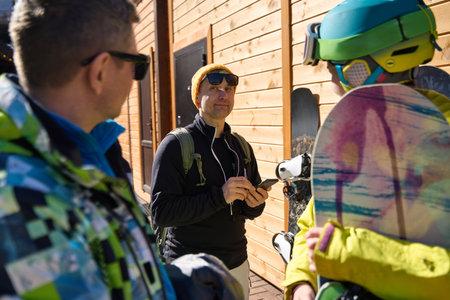 Three Friends is Chatting Before Snowboarding