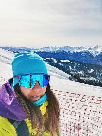Alpine Skier Selfie with Mountain Rangeの写真素材