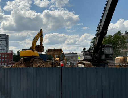 Building destruction, demolition of a building by an yellow excavators