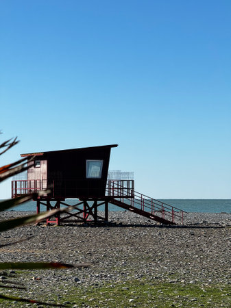 Lifeguard Hut on Rocky Beach with Ocean Viewの写真素材