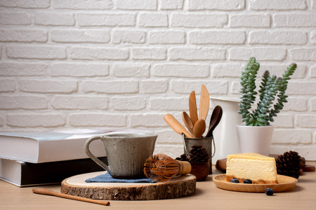 Close up shot cup of coffee and cake with book on table in coffee shop cafe/copy spaceの写真素材