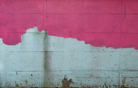 The brick wall is painted pink, not yet started off.の写真素材