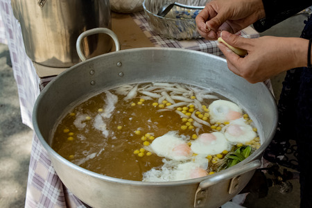 Molding dough as round balls, boiled in the eggs, coconut milk and taro are sweets.の写真素材