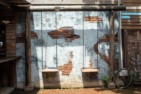 Swing chairs and the old plaster walls.の写真素材