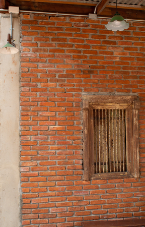 Striped brick walls and wooden window is used as the background.の写真素材