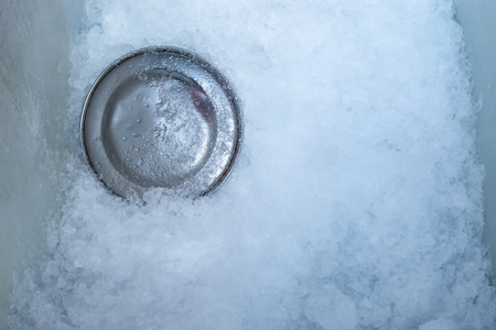 Stainless steel plate for scooping ice. In iceの写真素材