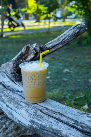 Iced coffee is placed with a log.の写真素材