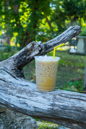 Iced coffee is placed with a log.の写真素材
