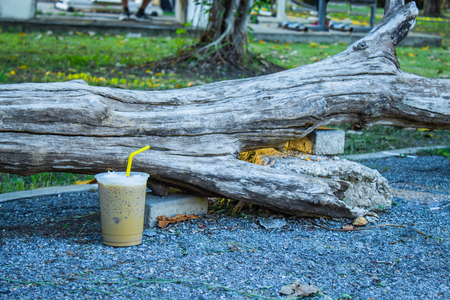 Iced coffee is placed with a log.の写真素材