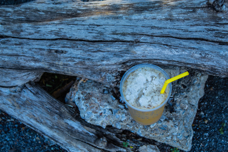 Iced coffee is placed with a log.の写真素材