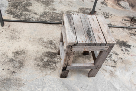 Old wooden chair on cement floor