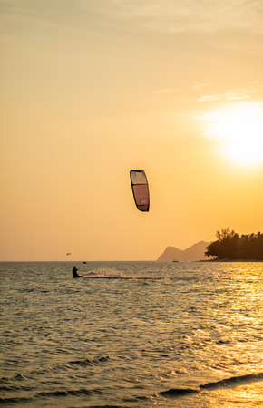 Tourists enjoy Kitesurfer surfing in the sea.の写真素材