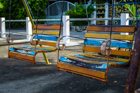 Swing chairs for children in park.の写真素材