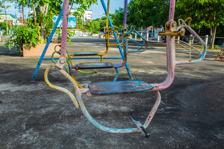 Swing chairs for children in park.の写真素材