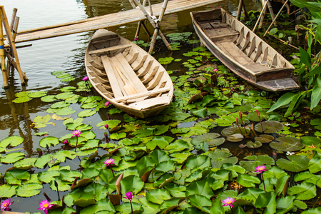 Wooden boat In the pink lotus ponds.の写真素材