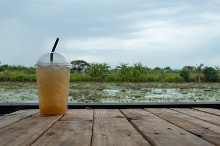 Sweet water from sugar palm on the table ,With the beauty of the Lotus pond.の写真素材
