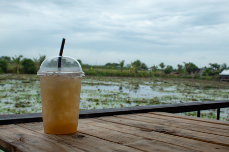 Sweet water from sugar palm on the table ,With the beauty of the Lotus pond.の写真素材