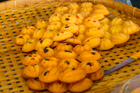 Thai cake ,Egg cake with small pieces of candy Thailand On bamboo basket.の写真素材