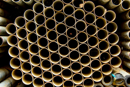 Old stainless steel pipes in stacks.