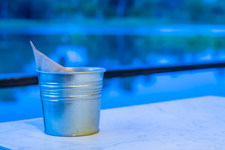 Galvanized cans on the table, white in a restaurant on the raft.の写真素材