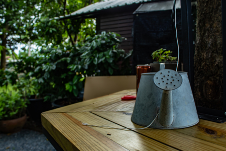 Galvanized cans. Irrigation water on table in garden.の写真素材