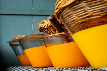 Fresh orange juice in a glass jar with a lid baskets.の写真素材