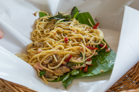 The spaghetti spicy fried clams on the banana leaves.の写真素材