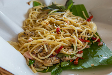 The spaghetti spicy fried clams on the banana leaves.の写真素材