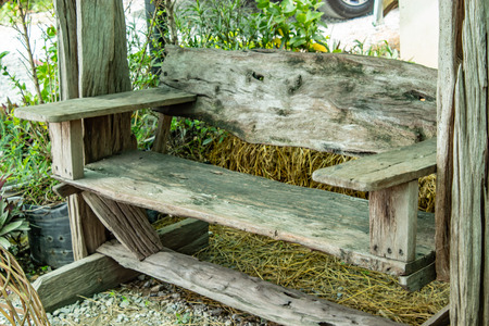 Tables and chairs made from tree in the garden.の写真素材
