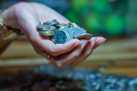 Many coins in the hands of women.の写真素材