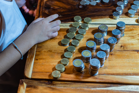 Many coins on a wooden tableの写真素材