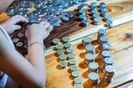 Many coins on a wooden tableの写真素材