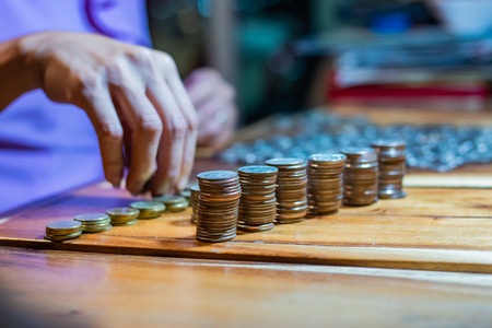 Many coins on a wooden tableの写真素材