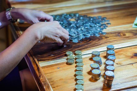 Many coins on a wooden tableの写真素材