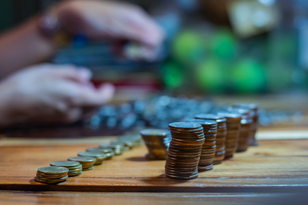Many coins on a wooden tableの写真素材