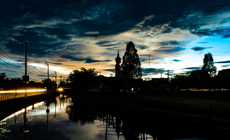 Sunset behind Wat Lad Pha Dook , Temple in Nonthaburi , Thailand.の写真素材