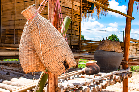 Fishing creel, Bamboo basket hang on the terrace of wood and bright blue sky.の写真素材