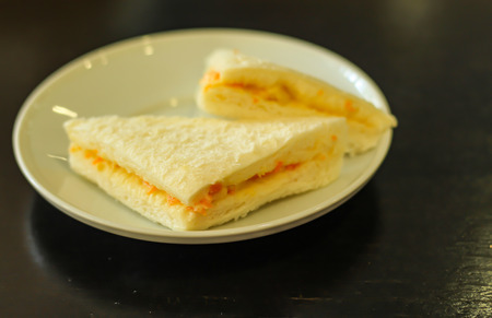 Bread sandwich in a white plate on the table.の写真素材