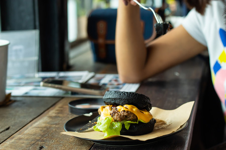 Hamburger black pork on the plate on a wooden table.の写真素材