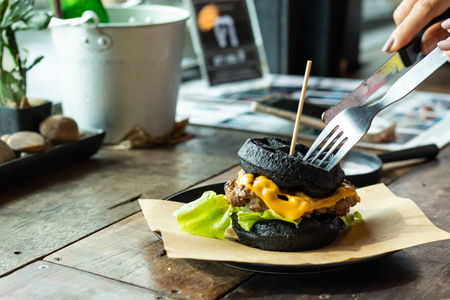 Hamburger black pork on the plate on a wooden table.の写真素材