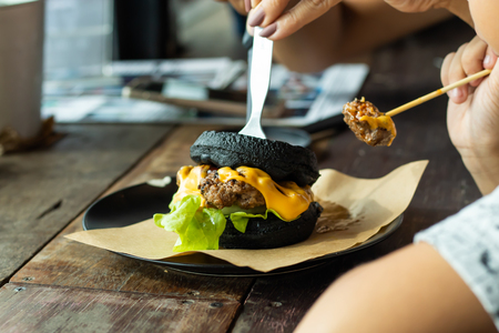 Hamburger black pork on the plate on a wooden table.の写真素材