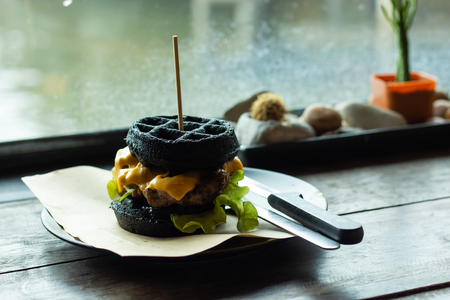 Hamburger black pork on the plate on a wooden table.の写真素材