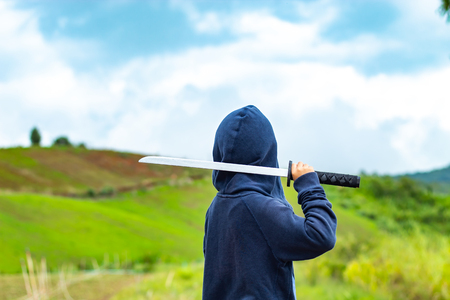 Portrait of a boy holding a wooden sword play.の写真素材